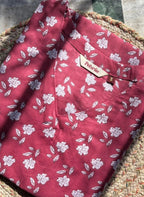 Red floral shirt with a brand tag on a woven surface Short Kurti
